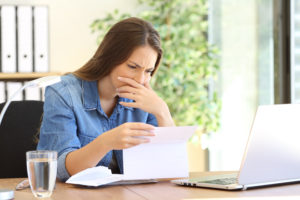 woman getting bad news in mail